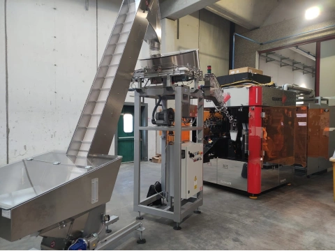 Quantix NOVUM digital printer connected to a conveyor system in an industrial environment.
