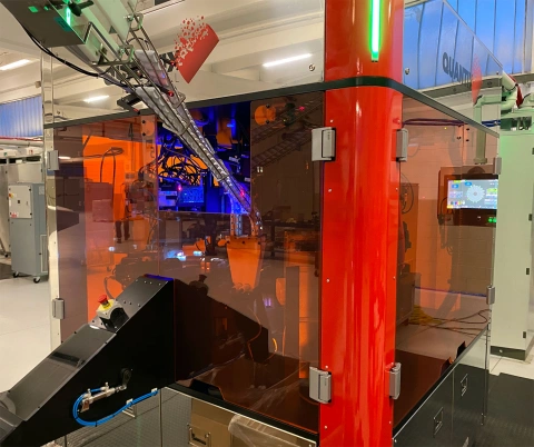 Quantix NOVUM digital printing machine in operation with advanced automation features and precision-controlled mechanisms.