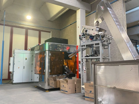 Quantix NOVUM digital printing machine paired with an automated material feeding system.
