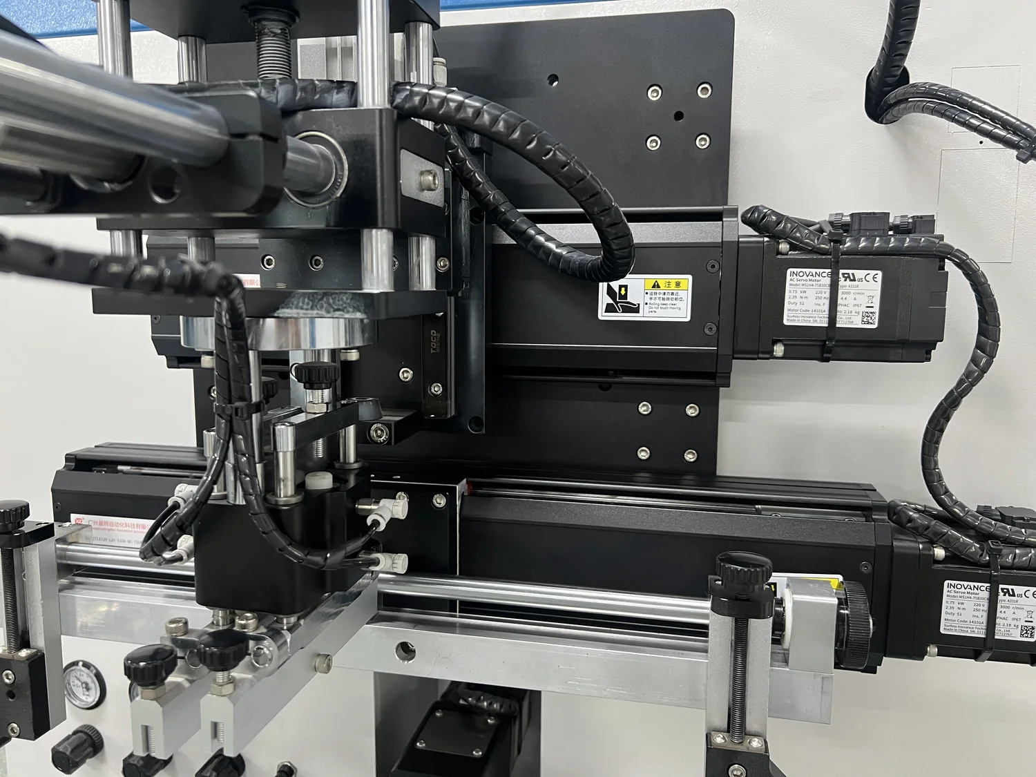 Close-up of Inovance servo motors and linear motion components on the DT-CNC-120S