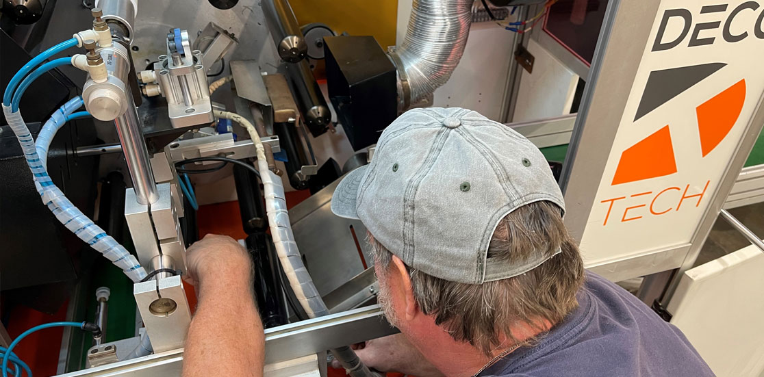 Deco Tech technician servicing industrial printing equipment