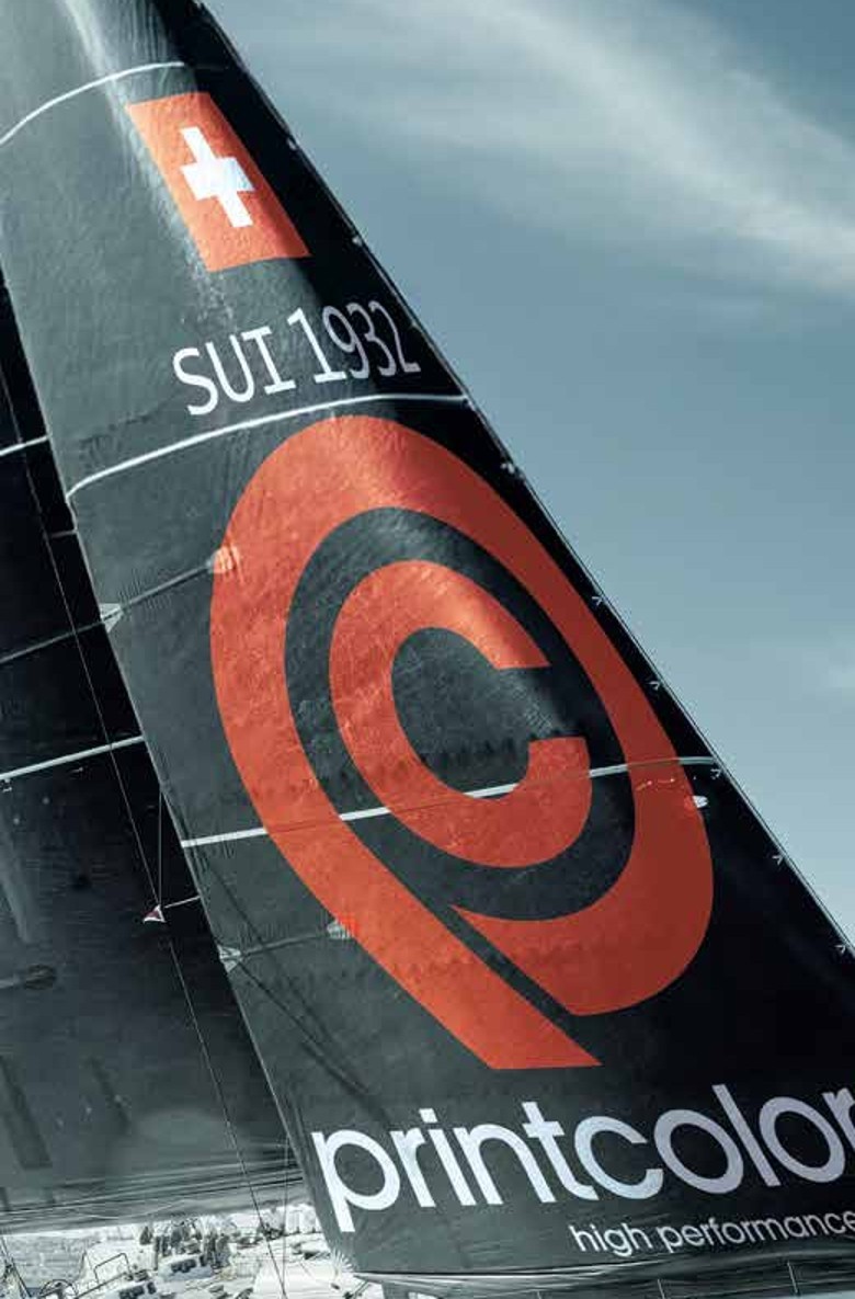 Close view of a decorated composite racing sail under load